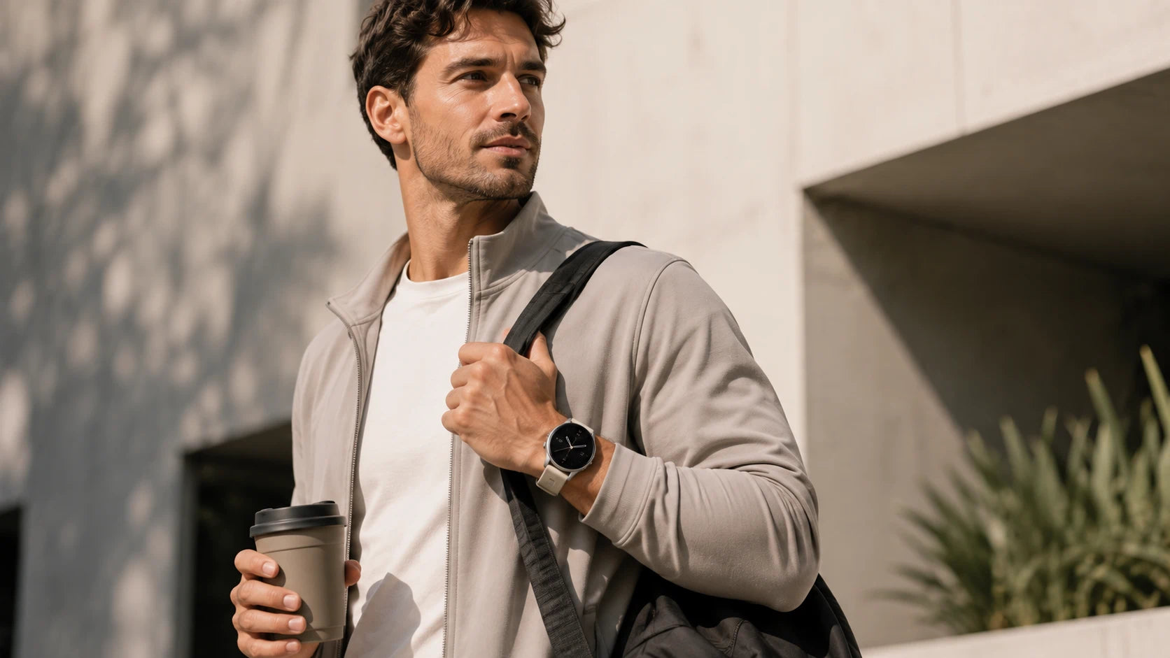 Man wearing a TECHQO smartwatch in an everyday lifestyle setting with a modern casual look